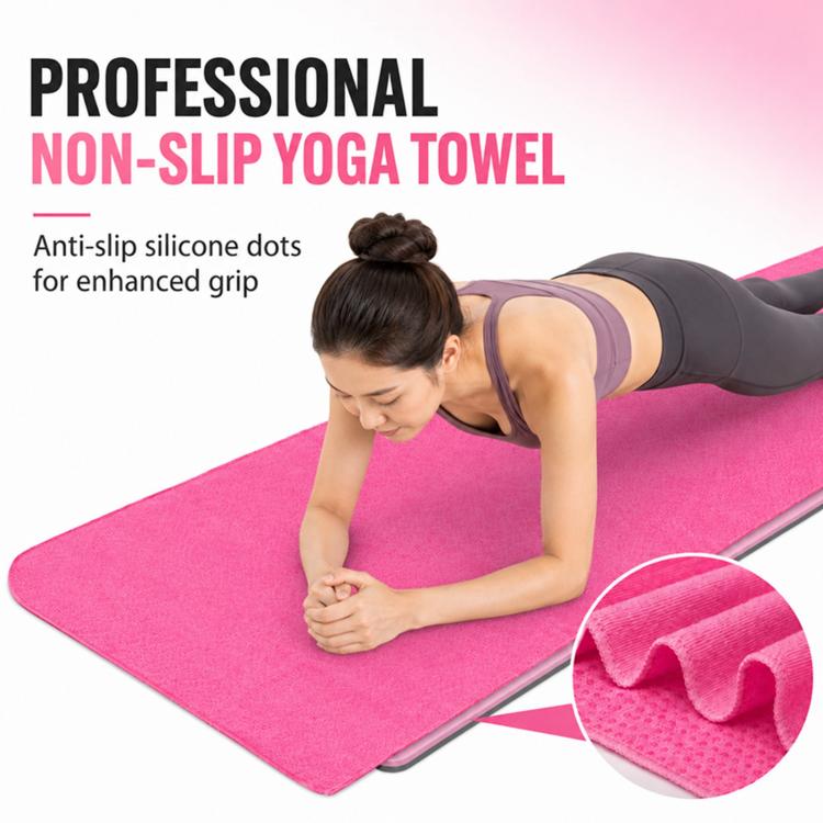 Pink yoga towel with anti-slip dot texture and folded edge detail visible.