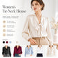 White women’s tie-neck blouse with bow neckline, long sleeves, and button cuffs