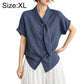 Women’s tie-neck button-front blouse in textured dark blue, model wearing size XL.