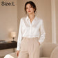 White satin long-sleeve button-up shirt with pointed collar, button placket, and cuffs
