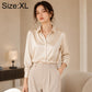 Cream satin long-sleeve button-up shirt with pointed collar and button placket detail