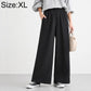High-waisted wide-leg women’s pants with elastic waist, solid black.