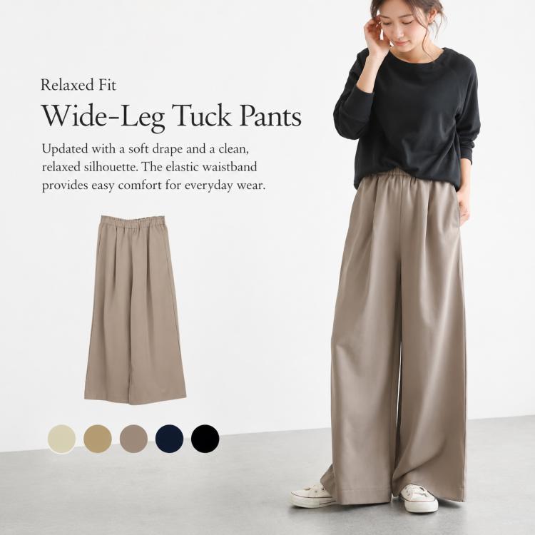 Beige high-rise wide-leg pants with elastic waistband and soft drape