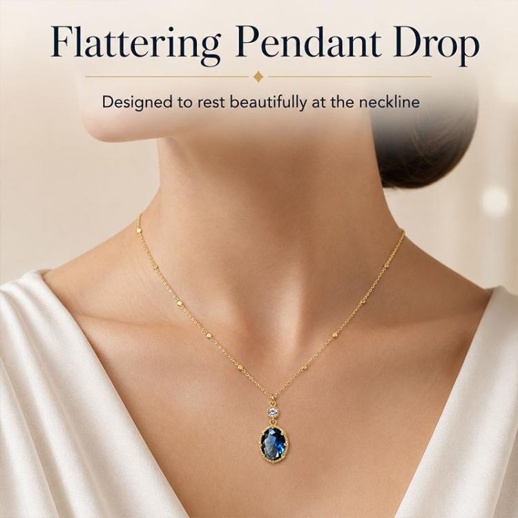 Gold-tone pendant necklace with oval blue stone drop and tiny clear round top