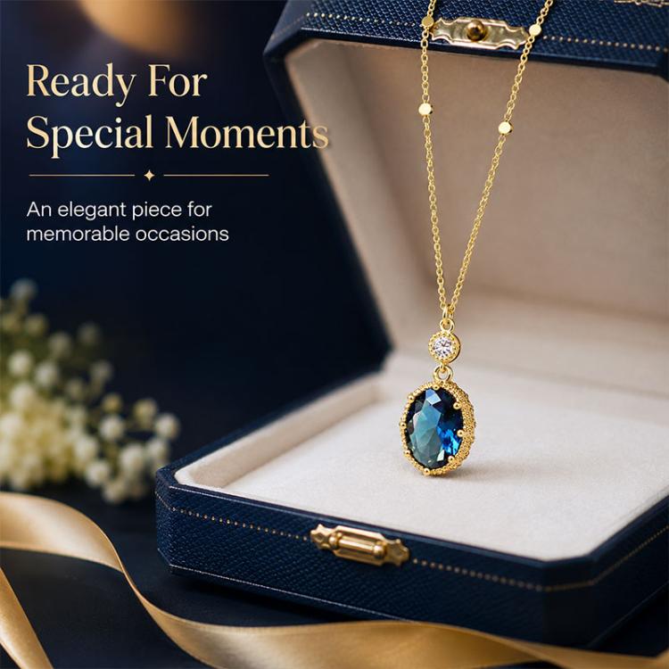 Gold-tone pendant necklace featuring oval blue stone drop with clear top crystal
