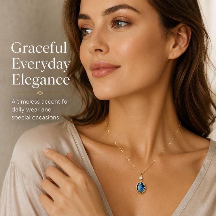 Gold-tone pendant necklace with oval blue crystal and small round clear stone at top