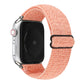 Coral pink stretchy nylon Apple Watch band with black hook-and-loop clasp