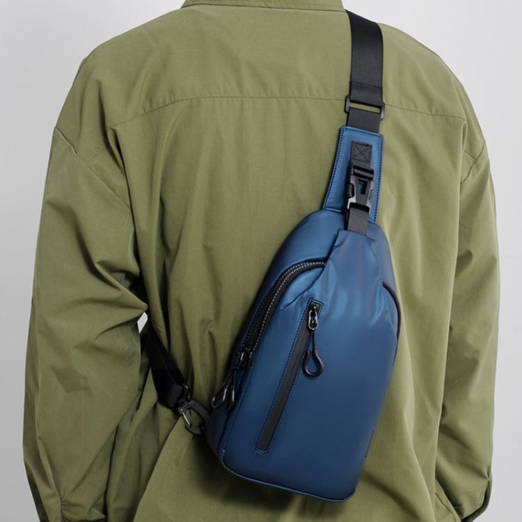 Blue crossbody chest sling bag with adjustable strap and front vertical zip pocket.