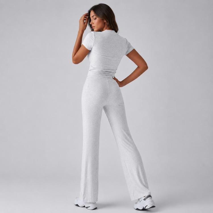 Women’s gray short-sleeve crop top and wide-leg drawstring pants, back-lean pose