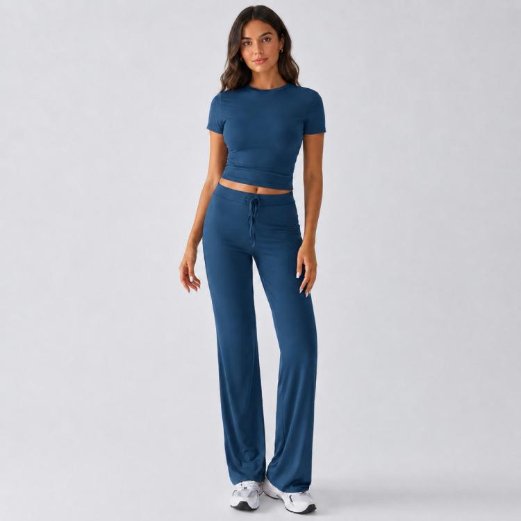 Blue two-piece outfit featuring fitted crop top and drawstring wide-leg trousers