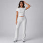 Light gray two-piece set with short-sleeve crop top and high-rise drawstring pants