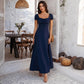 Women's navy French-style maxi dress with short bubble sleeves and ruched neckline