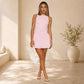 Pink sleeveless halter short dress with fitted bodice and tiered skirt, above-knee hem.