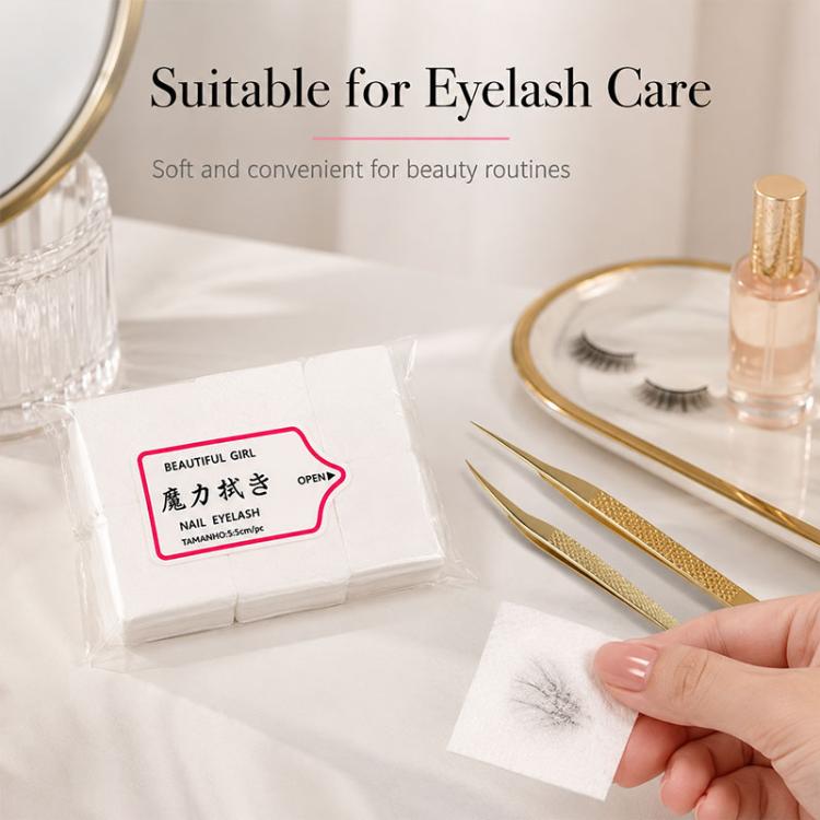 Disposable nail and eyelash wipes next to eyelash tools and rolled bottle on table