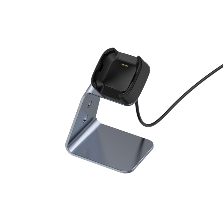 Grey aluminum smartwatch charger stand with black cradle and connected charging cable