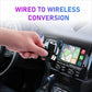 Wireless car adapter being plugged into a car’s USB port, ready for wireless use