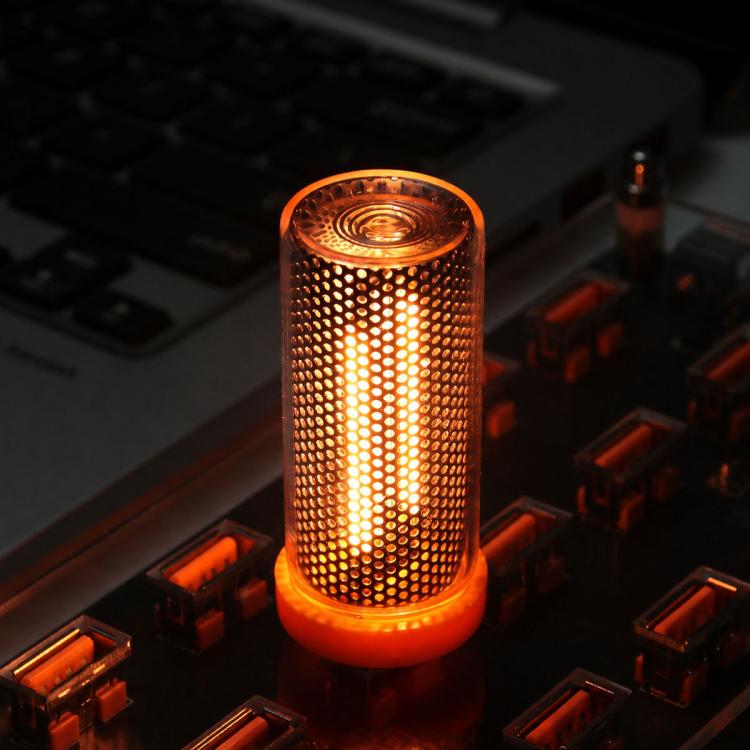 Yellow-orange glowing USB LED cylinder atmosphere light with dotted side grille