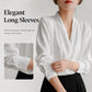 White satin V-neck blouse with long sleeves and gathered button cuff detail