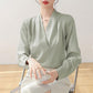 Light green satin V-neck blouse with long sleeves and smooth pleated finish