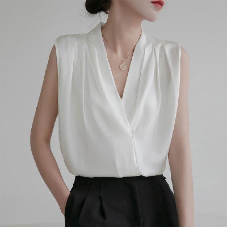 White sleeveless satin blouse with V-neck and center front seam, draped fit