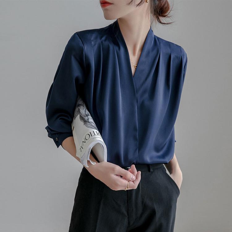 Navy satin V-neck blouse with long sleeves, draped front and shoulder pleats