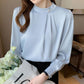 Light blue chiffon blouse with stand collar, pearl button, long sleeves, pleats