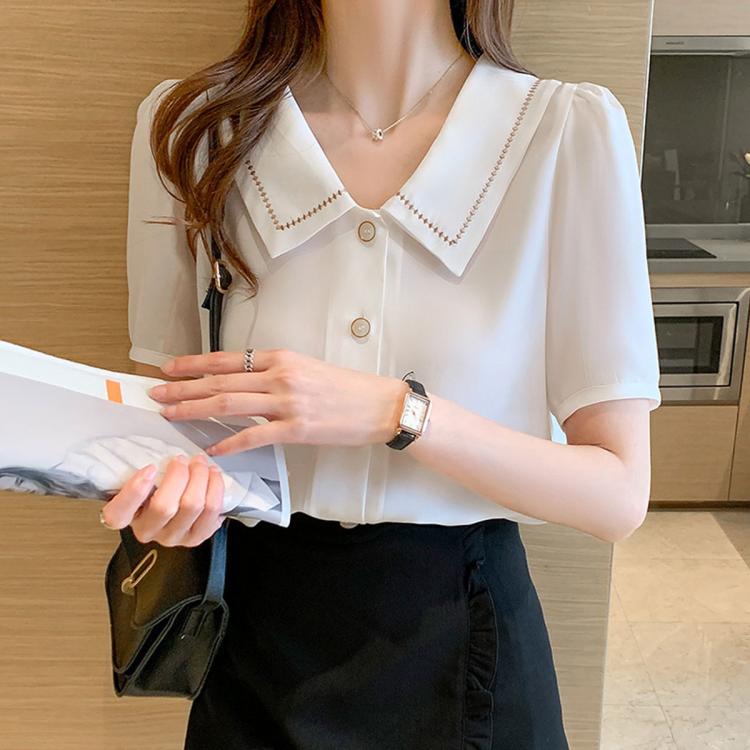 White chiffon sailor-collar blouse with short sleeves and gold-button front on model