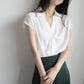 White twist V-neck cap-sleeve blouse with front drape and neat collar details