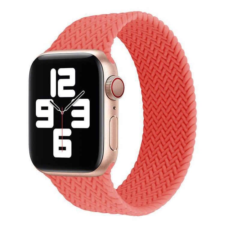 Coral red woven silicone watch band with smartwatch attached