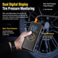 Hand holding black tire pressure monitor pump with dual digital display and orange ring control