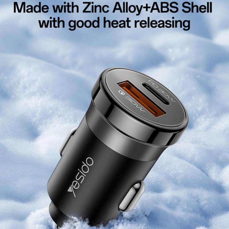 Black car charger with round face and orange port highlights, weather-ready design