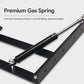 Black gas spring lift bracket with steel plates and mounting holes, close-up