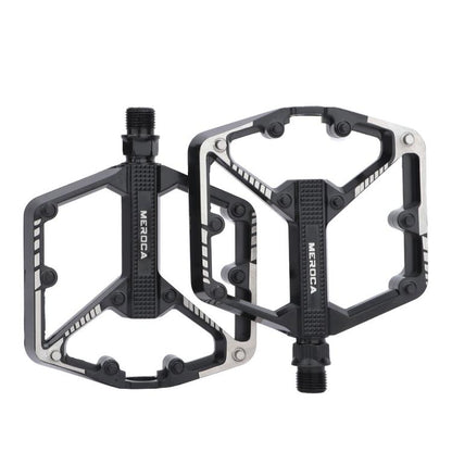 Black mountain bike pedals with dual platform and serrated grip surfaces