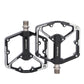 Black mountain bike pedals with dual platform and metal traction studs