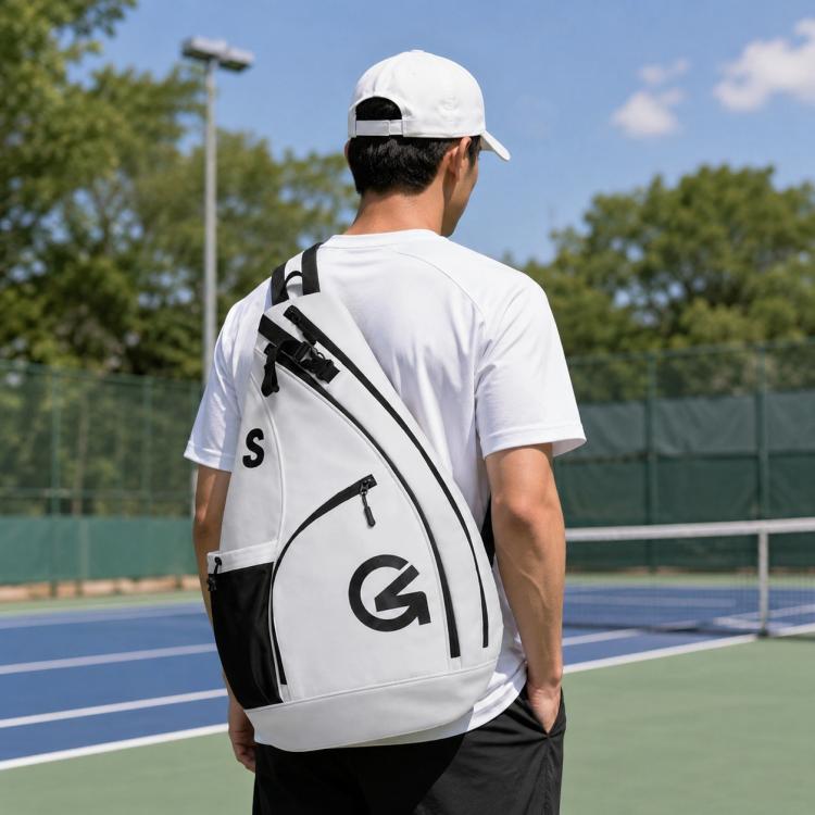 White sports crossbody bag with black side pocket and bold logo on front panel
