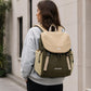 Olive and tan backpack with front flap and hanging drawstring cords