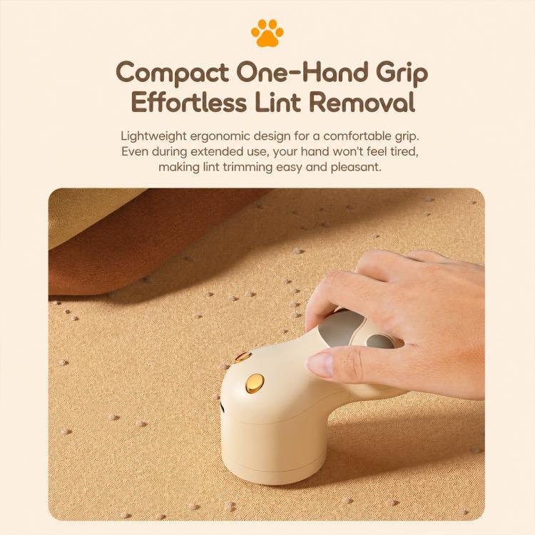 Off-white electric lint remover with one-hand grip, cat-paw pawprint pattern.