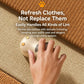 White cat paw electric lint remover being used on a woven fabric surface