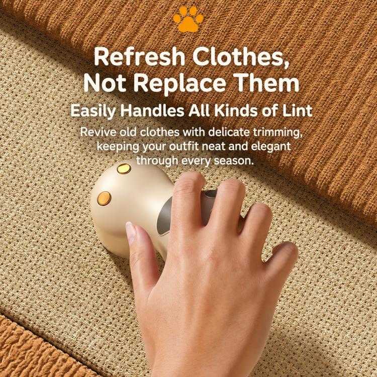 White cat paw electric lint remover being used on a woven fabric surface