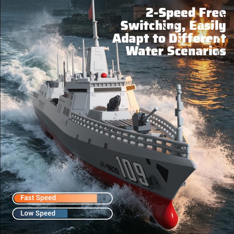 RC destroyer model speeding across water, gray rails and red nose visible