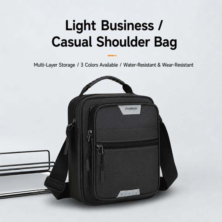Men’s crossbody bag in black with padded handle, front zip pocket, and wide strap
