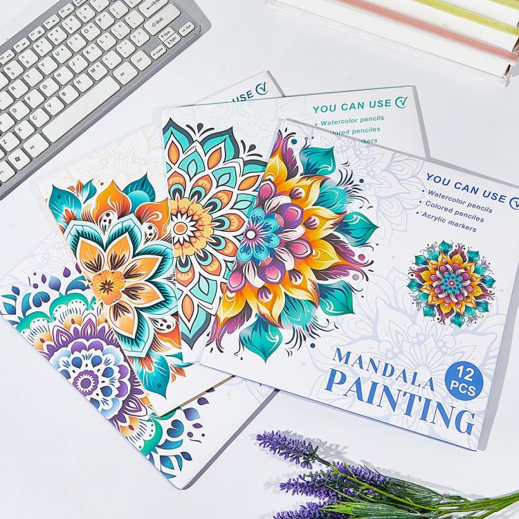 Mandala painting sets on a desk, colorful flower designs on multiple pages