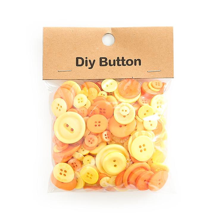 Pack of round resin buttons, peach and yellow mixed sizes with 2-4 holes, in clear bag