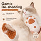 Cat Claws de-shedding grooming brush with brown silicone tips, used on a white cat