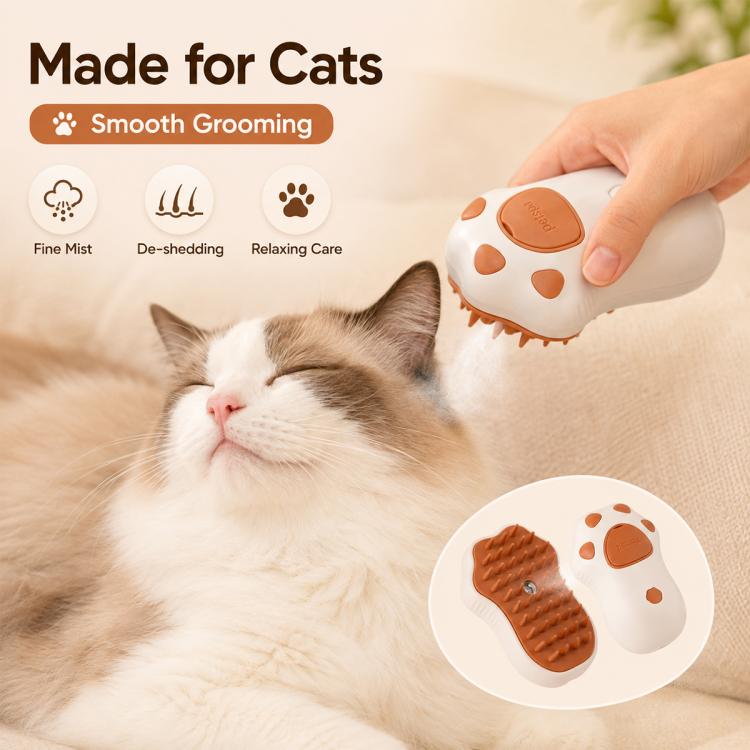 Cat Claws grooming brush with brown silicone pad, held above a sleeping cat