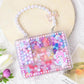 Pearl-look bead bracelet with clear organizer box of colorful beads and charms