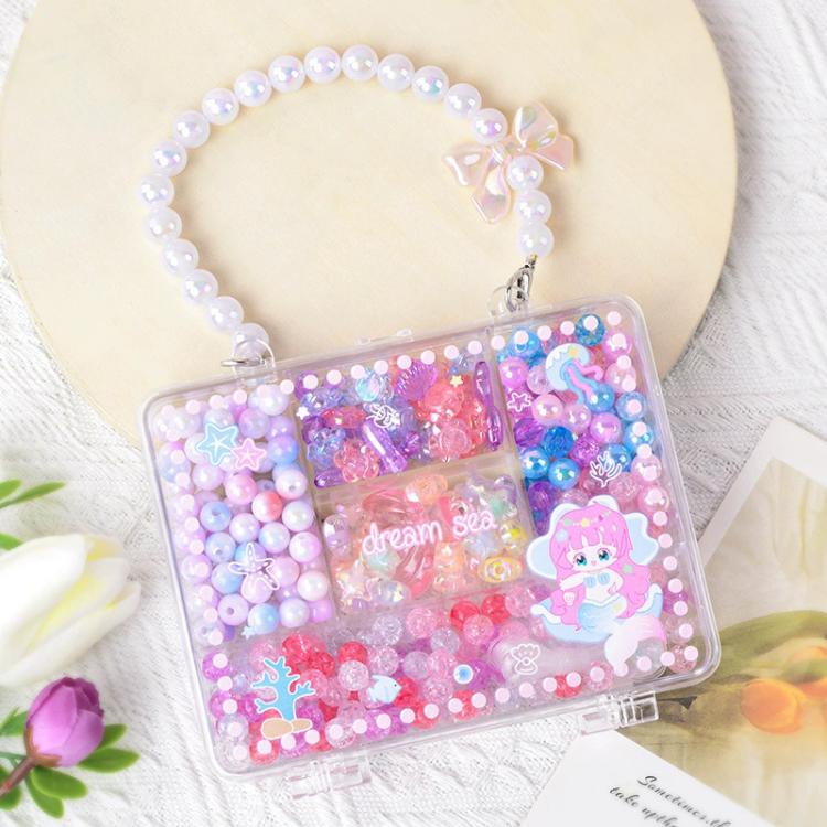 Pearl-look bead bracelet with clear organizer box of colorful beads and charms