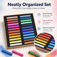 Pastel chalk sticks set in tray with several colorful sticks laid around the open box.