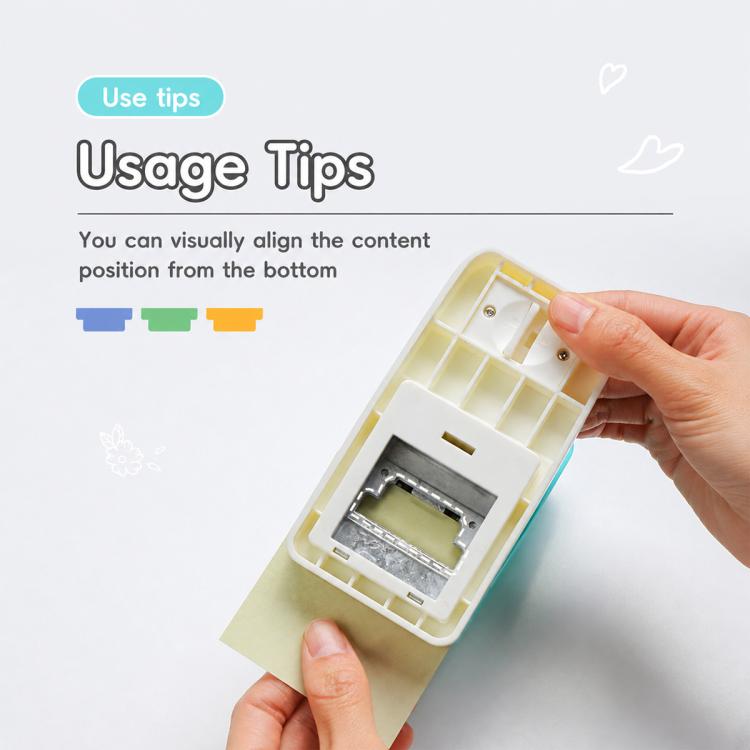 Light-colored index tab puncher open interior with hand aligning a paper tab