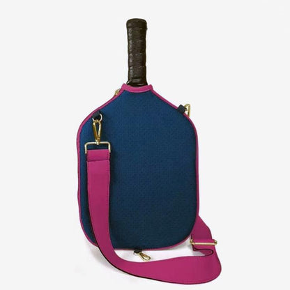 Navy blue neoprene paddle bag with pink shoulder strap and gold-tone clips.